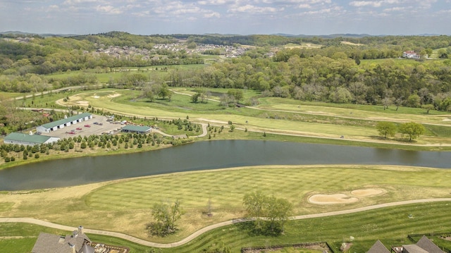 drone / aerial view of a nearby body of water and a golf club