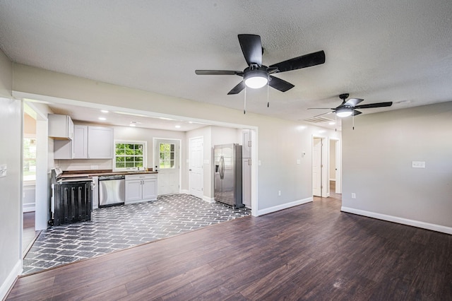 204 Wilson Ave, Auburn, KY 42206 - unfurnished living room with wood finished floors, a ceiling fan, baseboards, a textured ceiling, and recessed lighting