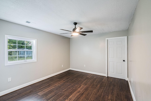 204 Wilson Ave, Auburn, KY 42206 - spare room featuring dark wood finished floors, a textured ceiling, a ceiling fan, and baseboards