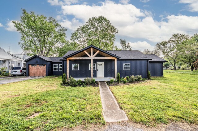 204 Wilson Ave, Auburn, KY 42206 - view of front of home with a garage, covered porch, a front lawn, and asphalt driveway