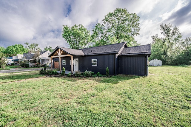 204 Wilson Ave, Auburn, KY 42206 - view of front of property with a front yard, a shed, roof with shingles, and an outbuilding