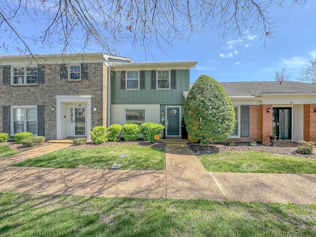 1002 E Northfield Blvd # A102, Murfreesboro, TN 37130 - view of front facade with brick siding, a front yard, and board and batten siding