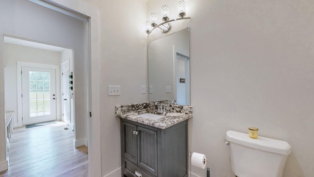 548 Buddy Rd, Burns, TN 37029 - bathroom with wood finished floors, toilet, baseboards, and vanity