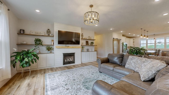548 Buddy Rd, Burns, TN 37029 - living area featuring a chandelier, light wood-style floors, recessed lighting, and a large fireplace