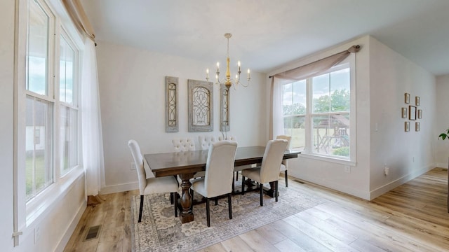 548 Buddy Rd, Burns, TN 37029 - dining space with a chandelier, wood finished floors, and baseboards