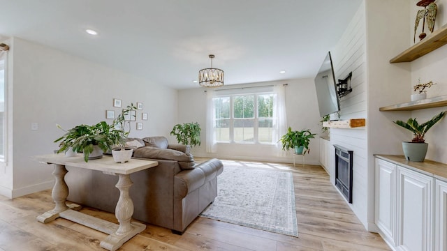548 Buddy Rd, Burns, TN 37029 - living area with light wood-style flooring, a fireplace, a chandelier, recessed lighting, and baseboards