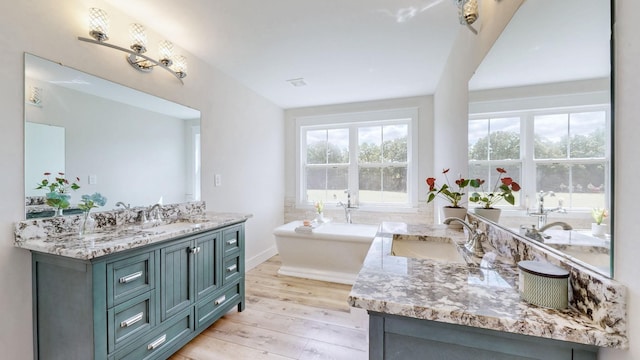548 Buddy Rd, Burns, TN 37029 - full bath with wood finished floors, a freestanding tub, and two vanities