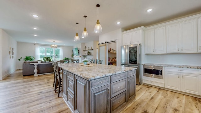 548 Buddy Rd, Burns, TN 37029 - kitchen featuring appliances with stainless steel finishes, white cabinets, light wood-style floors, and recessed lighting