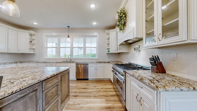 548 Buddy Rd, Burns, TN 37029 - kitchen with appliances with stainless steel finishes, open shelves, white cabinets, a sink, and light wood finished floors