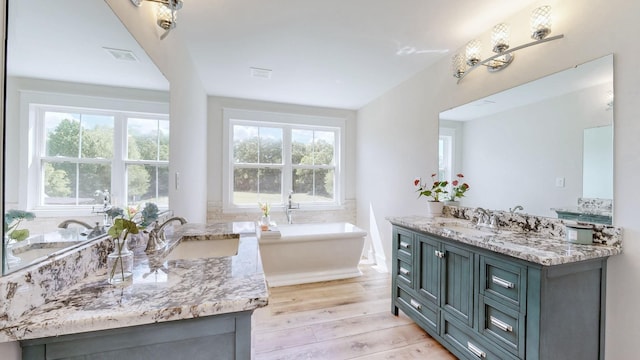 548 Buddy Rd, Burns, TN 37029 - full bath featuring vanity, wood finished floors, and a freestanding tub