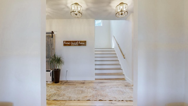548 Buddy Rd, Burns, TN 37029 - staircase featuring wood finished floors and a chandelier