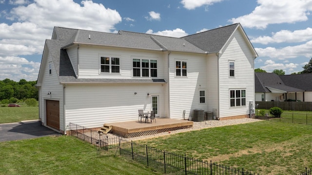 548 Buddy Rd, Burns, TN 37029 - back of property featuring a deck, asphalt driveway, an attached garage, a shingled roof, and cooling unit