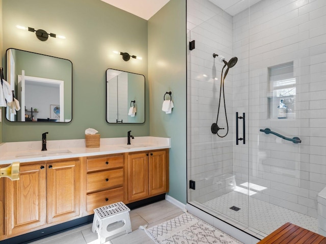 full bath with a shower stall, tile patterned flooring, and double vanity