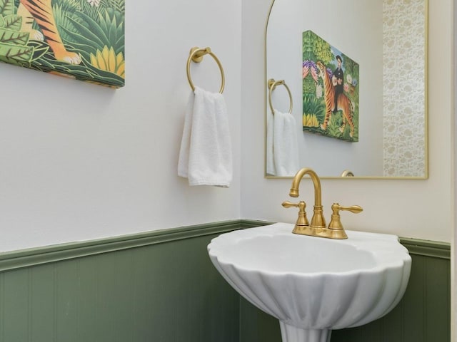 bathroom with a sink and wainscoting
