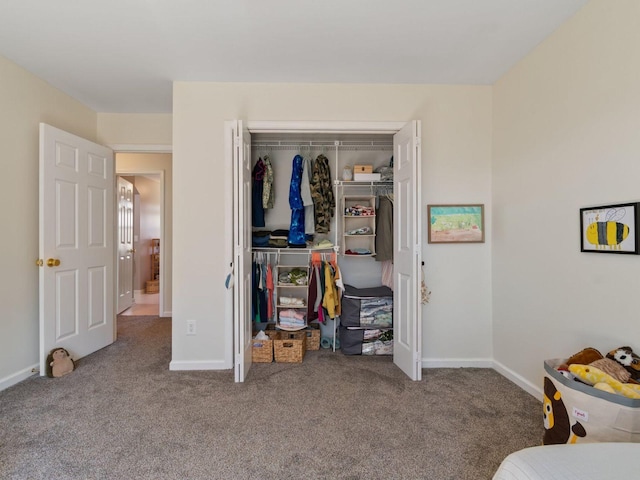 bedroom with carpet floors, a closet, and baseboards