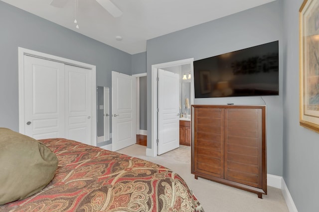 bedroom featuring light carpet, a closet, and baseboards