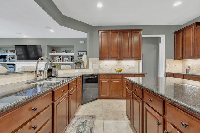 kitchen featuring black dishwasher, a sink, dark stone countertops, decorative backsplash, and brown cabinets