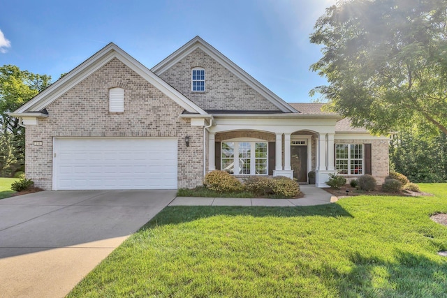 view of front of property with brick siding, a front yard, driveway, and an attached garage