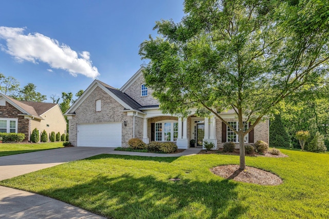 view of front facade featuring driveway, a front yard, brick siding, and an attached garage