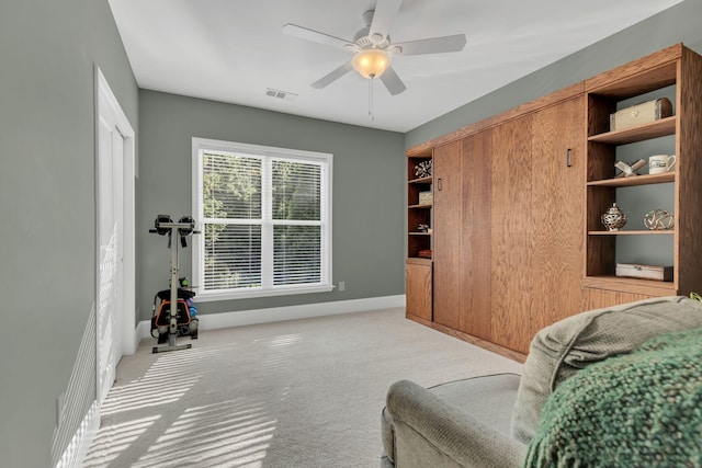sitting room featuring carpet flooring, a ceiling fan, and baseboards