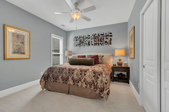 bedroom with light colored carpet, baseboards, and ceiling fan