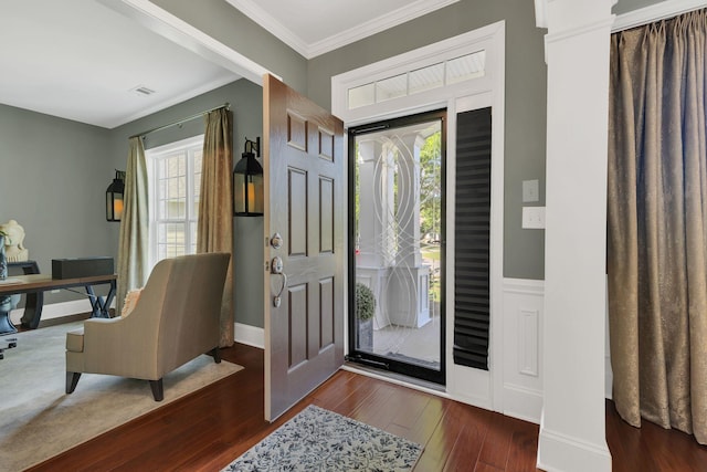 foyer with wood finished floors, plenty of natural light, crown molding, and baseboards