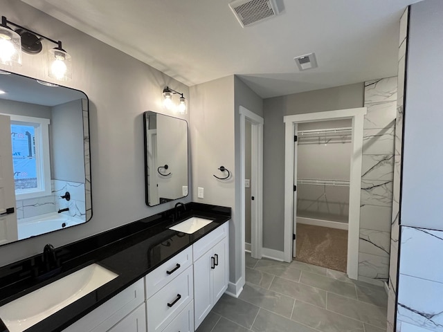 614 Woodrush Dr, Clarksville, TN 37040 - bathroom featuring double vanity, a spacious closet, and baseboards