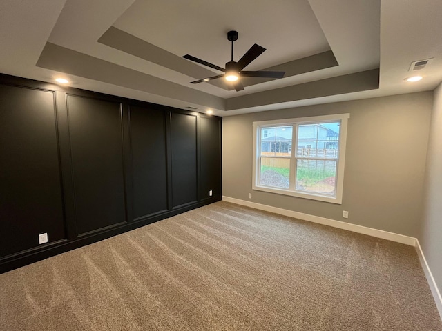614 Woodrush Dr, Clarksville, TN 37040 - spare room with a tray ceiling, a ceiling fan, light colored carpet, and baseboards