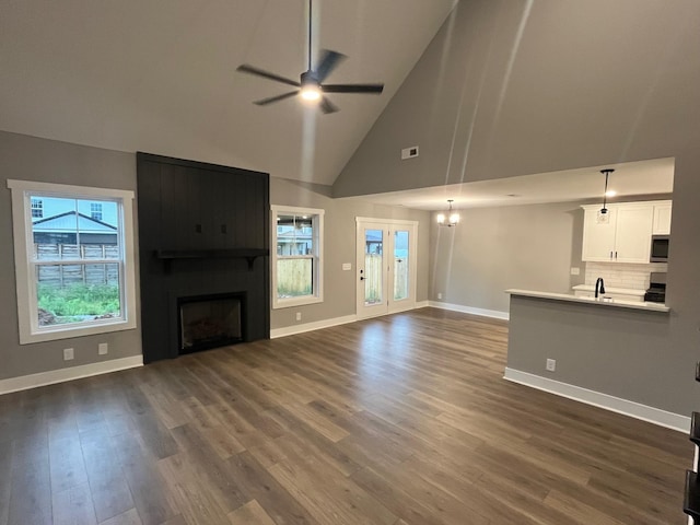 614 Woodrush Dr, Clarksville, TN 37040 - unfurnished living room with ceiling fan, a large fireplace, high vaulted ceiling, baseboards, and dark wood finished floors