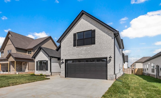 614 Woodrush Dr, Clarksville, TN 37040 - view of front of home with a garage, brick siding, and driveway