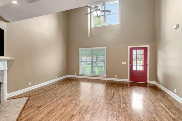 1317 Sam Houston Ave, Murfreesboro, TN 37129 - unfurnished living room with a towering ceiling, a ceiling fan, wood finished floors, and baseboards