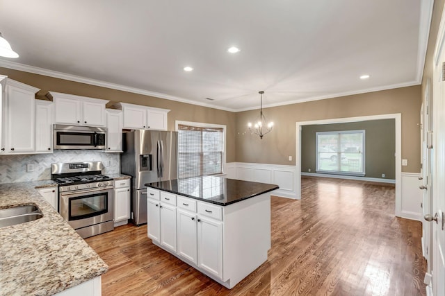 1317 Sam Houston Ave, Murfreesboro, TN 37129 - kitchen featuring appliances with stainless steel finishes, white cabinetry, a chandelier, pendant lighting, and light stone counters