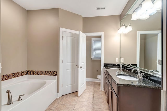 1317 Sam Houston Ave, Murfreesboro, TN 37129 - full bathroom with toilet, a garden tub, tile patterned flooring, double vanity, and baseboards