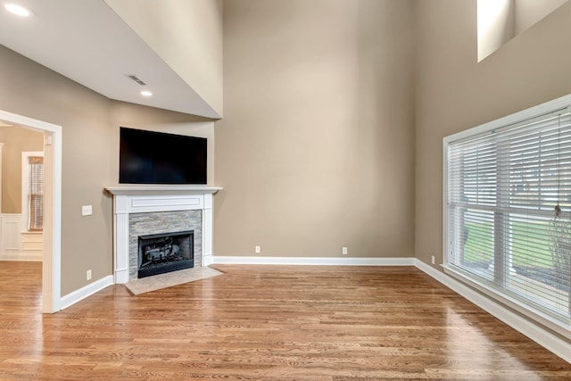 1317 Sam Houston Ave, Murfreesboro, TN 37129 - unfurnished living room featuring light wood-type flooring, a high ceiling, a fireplace, baseboards, and recessed lighting