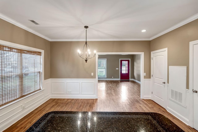 1317 Sam Houston Ave, Murfreesboro, TN 37129 - foyer entrance featuring a chandelier, crown molding, wood finished floors, and wainscoting