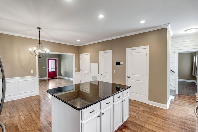 1317 Sam Houston Ave, Murfreesboro, TN 37129 - kitchen featuring crown molding, white cabinetry, wood finished floors, a chandelier, and wainscoting
