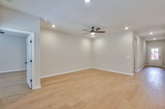 empty room featuring a ceiling fan, light wood-type flooring, baseboards, and recessed lighting
