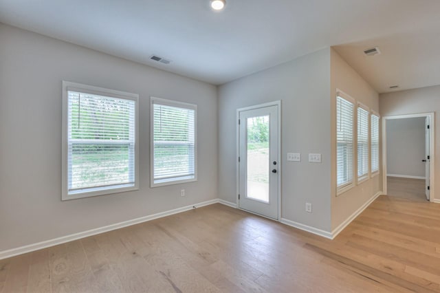 foyer featuring baseboards and light wood-style flooring