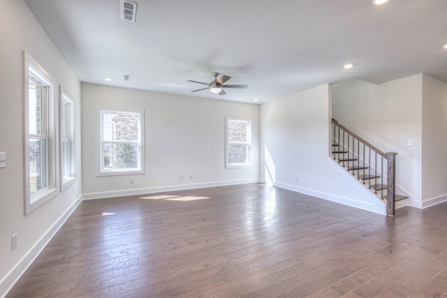 unfurnished living room featuring plenty of natural light, stairway, ceiling fan, dark wood-style flooring, and recessed lighting