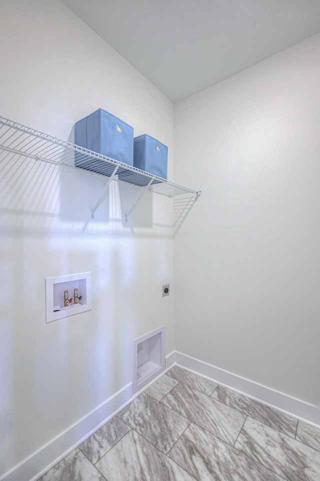washroom with hookup for an electric dryer, baseboards, and hookup for a washing machine