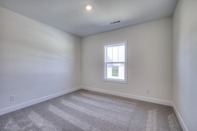 unfurnished room featuring carpet flooring and baseboards