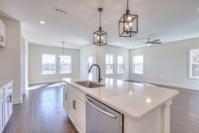 kitchen with a sink, stainless steel dishwasher, baseboards, open floor plan, and recessed lighting