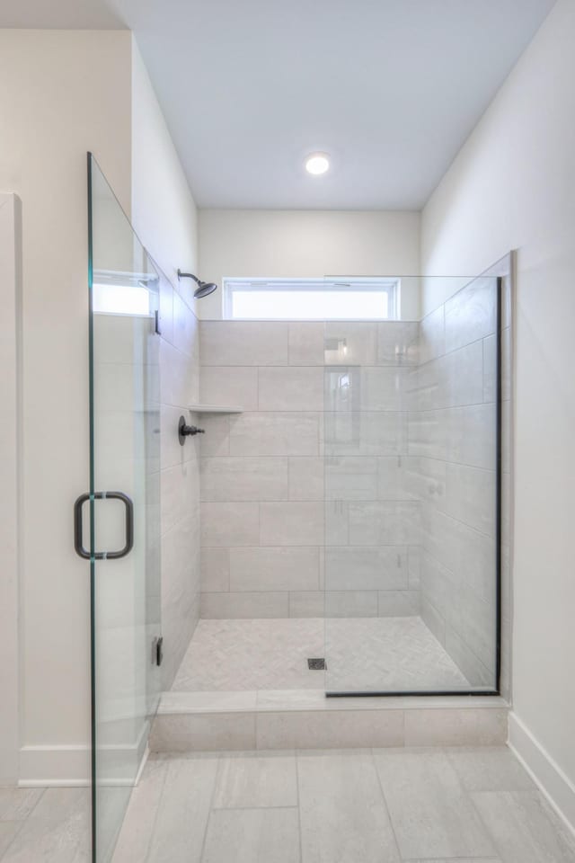 full bathroom featuring a stall shower, baseboards, tile patterned floors, and recessed lighting