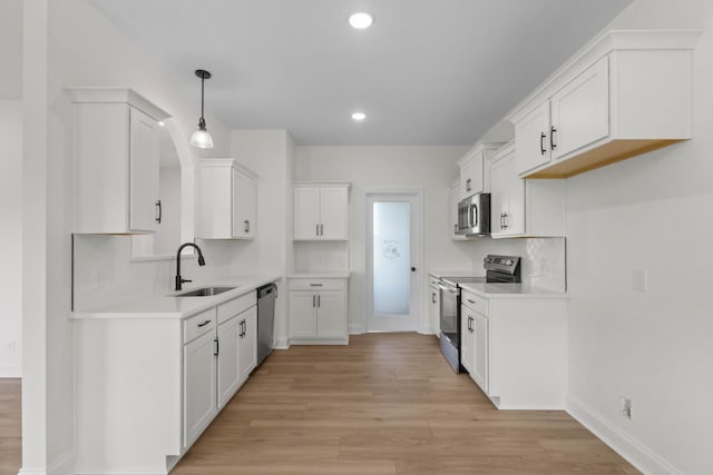 1 Shelton Ferry Rd, Southside, TN 37171 - kitchen with appliances with stainless steel finishes, a sink, light wood-type flooring, recessed lighting, and white cabinetry