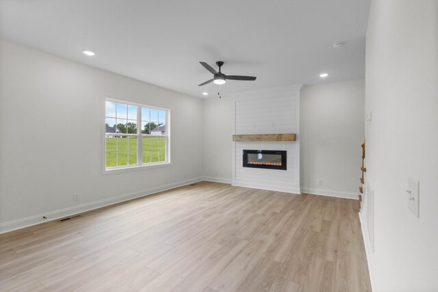 1 Shelton Ferry Rd, Southside, TN 37171 - unfurnished living room featuring light wood-style flooring, recessed lighting, a large fireplace, ceiling fan, and baseboards