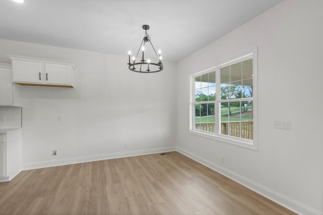 1 Shelton Ferry Rd, Southside, TN 37171 - unfurnished dining area featuring a chandelier, light wood finished floors, and baseboards