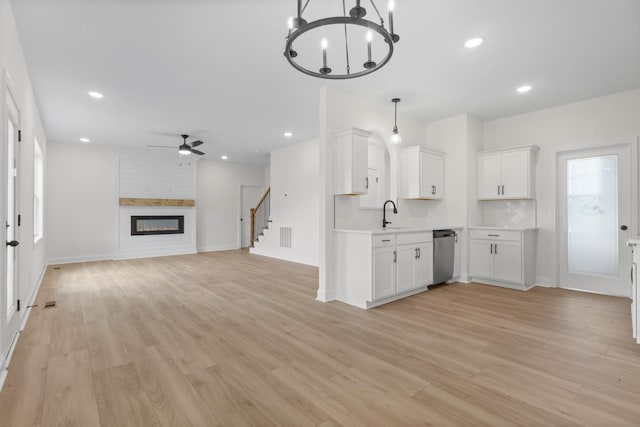 1 Shelton Ferry Rd, Southside, TN 37171 - kitchen featuring stainless steel dishwasher, ceiling fan, light countertops, a large fireplace, and a sink