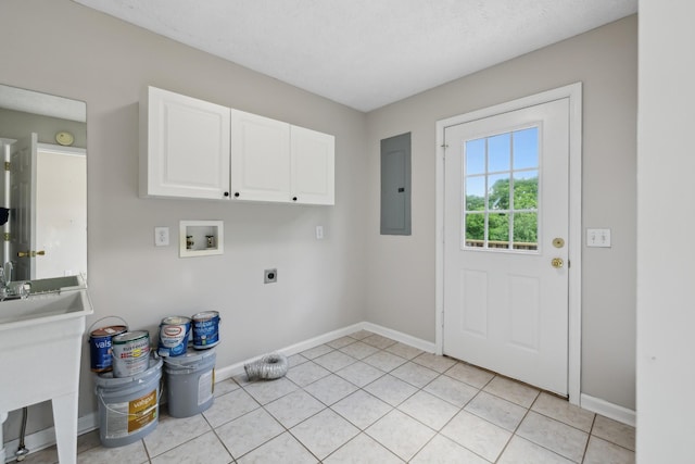 laundry area with hookup for a washing machine, electric panel, cabinet space, hookup for an electric dryer, and baseboards