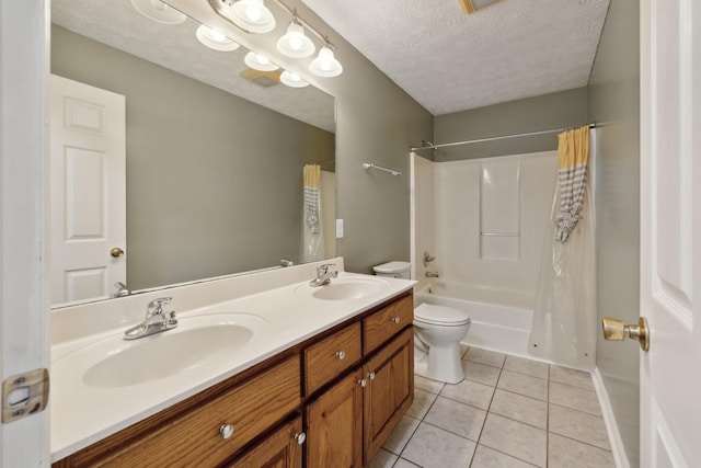 bathroom featuring a textured ceiling, tile patterned floors, toilet, double vanity, and shower / tub combo with curtain