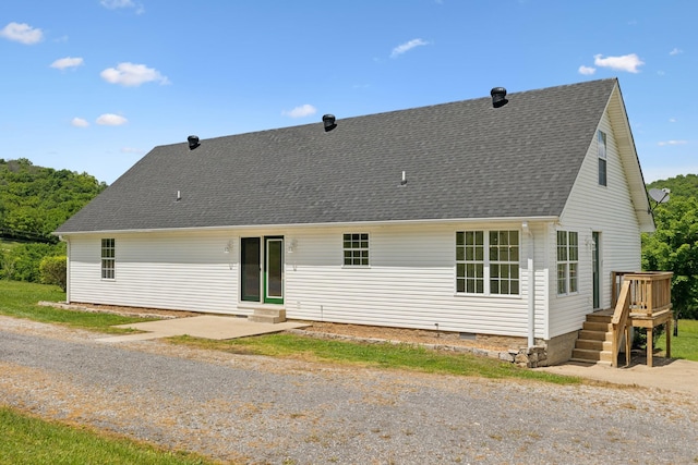 back of house featuring a deck, entry steps, a shingled roof, and crawl space
